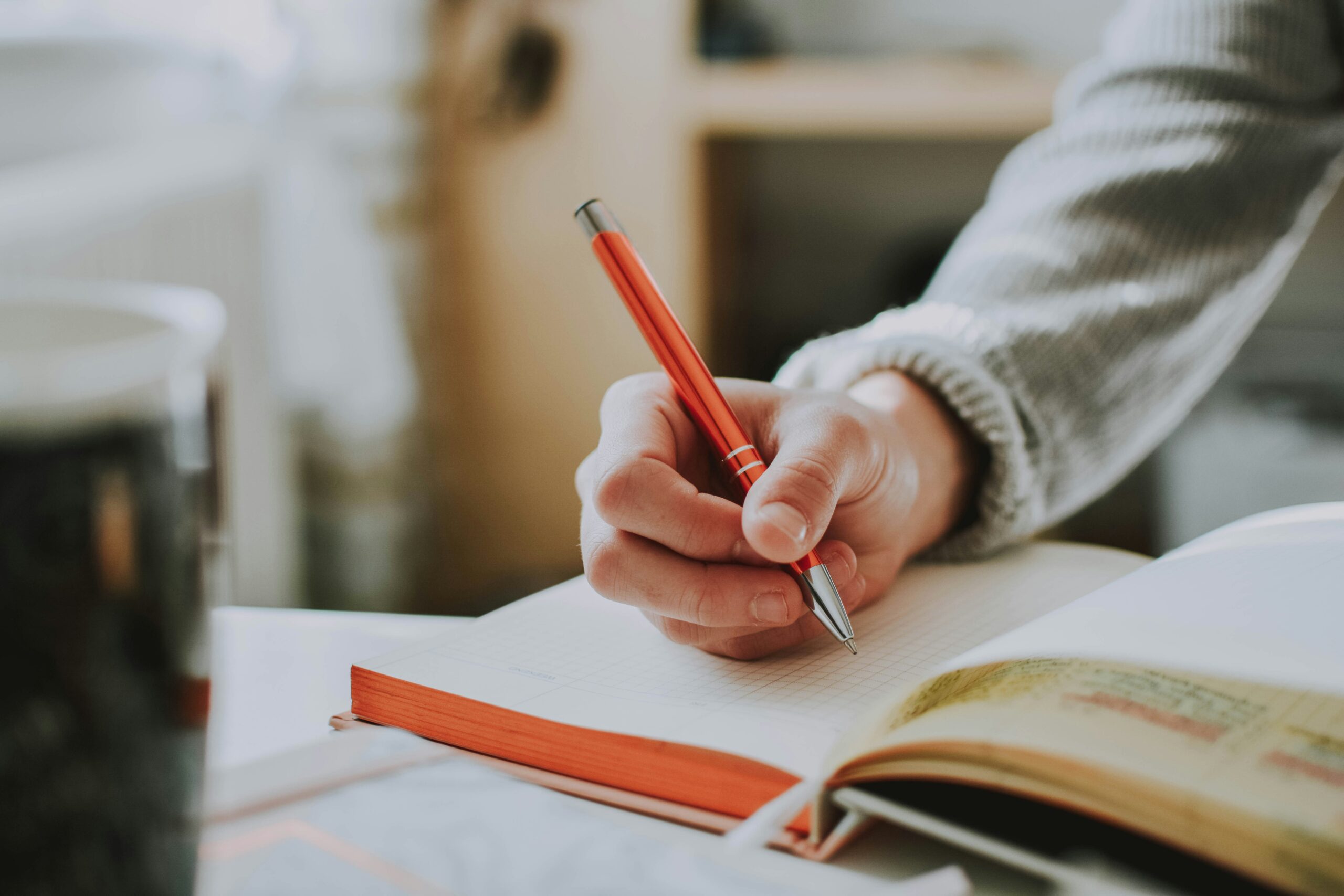 Student writing out personal goals in a notebook